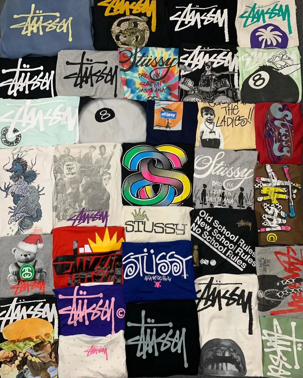 Collection of various Stussy t-shirts with different designs and colors.